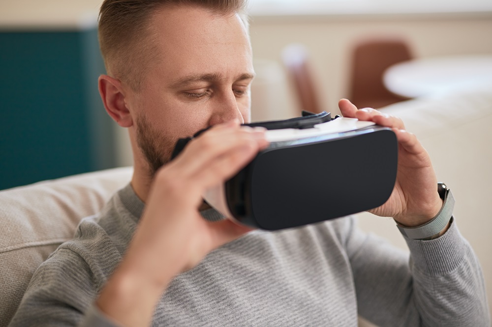 Man with VR glasses at home